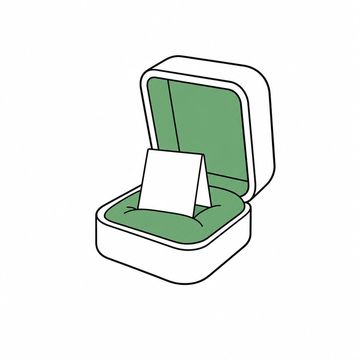 Line illustration: an oversized velvet ring box propped open to reveal, instead of a ring, a small folded proposal document with entirely blank unlettered pages, the satin lining of the box the accent colour